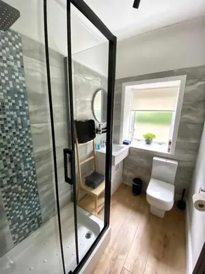 a bathroom with a shower and a toilet and a sink at Waverley Apartments, The Wheelhouse in Gourock
