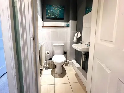 a small bathroom with a toilet and a sink at Garnethill Charm 3 Bed Flat Central Glasgow in Glasgow
