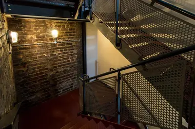 an empty staircase with a brick wall and a stair case at CODE - The Loft, Edinburgh in Edinburgh