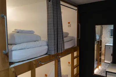 a room with three stacks of towels on a shelf at CODE - The Loft, Edinburgh in Edinburgh
