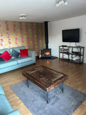a living room with a couch and a coffee table at Fairness Cottage, Near Comrie in Comrie