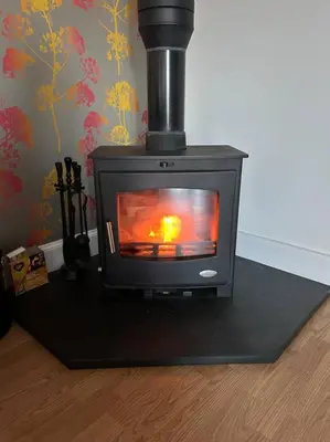 a black stove sitting on top of a table at Fairness Cottage, Near Comrie in Comrie