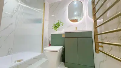 a bathroom with a toilet and a sink and a mirror at E'holidays in Edinburgh