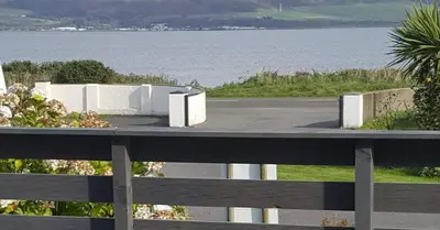 a view of a parking lot next to the water at Bay 1 in Kirkcolm