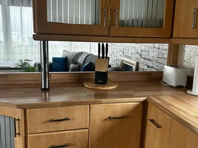 a kitchen with a wooden counter top and a window at Bay 1 in Kirkcolm