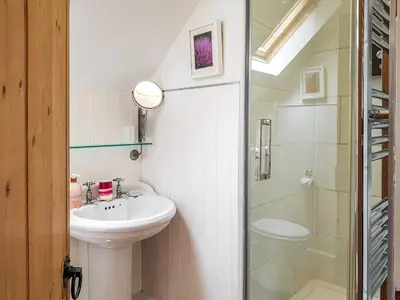 a bathroom with a sink and a toilet and a shower at Craigdarroch Cottage in Saint Fillans
