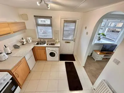a kitchen with a sink and a washing machine at Semi-detached 1-Bedroom Chalet at Maryville Caravan Site - Uddingston, Glasgow in Uddingston