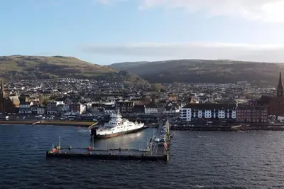 a large boat is docked at a dock in the water at Stunning Coach House in Largs