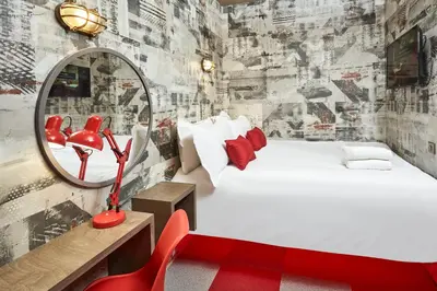 a bedroom with a white bed and a mirror at The Pier Rooms in Oban