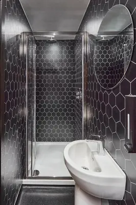 a bathroom with a toilet and a sink and a shower at The Pier Rooms in Oban