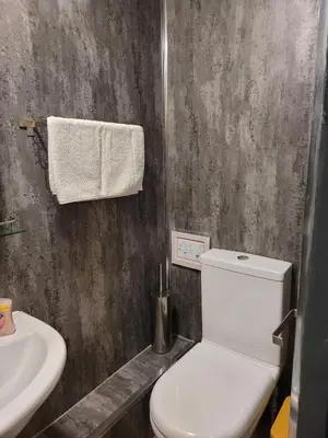 a bathroom with a white toilet and a sink at Luxe rooms in Edinburgh