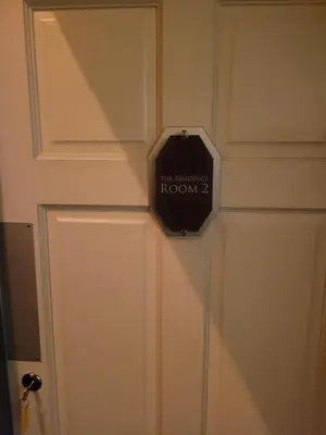 a door with a sign that reads the revolutionary room at Luxe rooms in Edinburgh