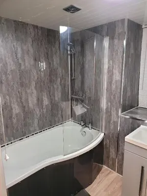 a bathroom with a bath tub and a sink at Luxe rooms in Edinburgh