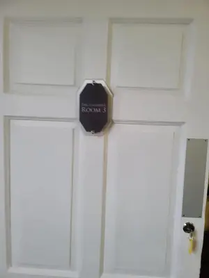 a door with a clock on the side of it at Luxe rooms in Edinburgh