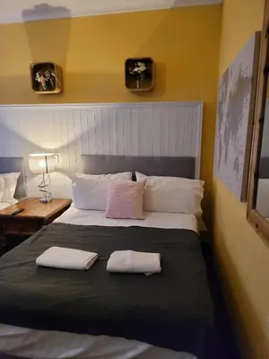 a bedroom with a large bed with two towels on it at Luxe rooms in Edinburgh