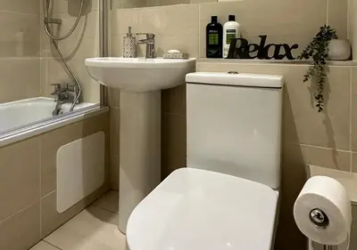 a bathroom with a white toilet and a sink at Trendy West End Apartment, Glasgow in Glasgow