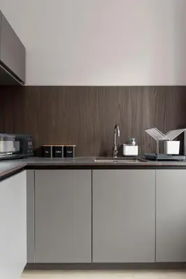 a kitchen with white cabinets and a sink at Modern George Street Studio sleeping 2 in Edinburgh
