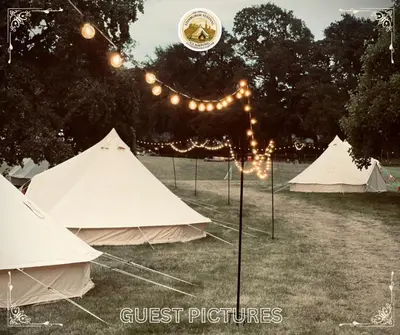 a group of tents in a field with lights at Edinburgh Festival Glamping By Stay Social Stays in Edinburgh