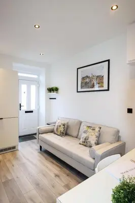 a living room with a couch and a table at City Centre Hub Stirling, On Street Parking. in Stirling