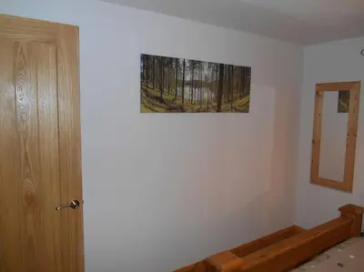 a room with a door and a picture on the wall at Eliburn Woodside Lodge in Livingston