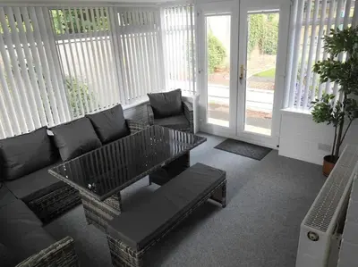 a living room with a couch and a coffee table at Eliburn Woodside Lodge in Livingston