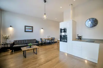 a living room with a couch and a table at Campbell Street Apartments in Oban