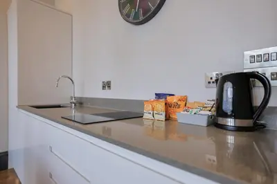 a kitchen counter with a sink and a coffee maker at Campbell Street Apartments in Oban