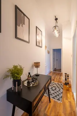 a living room with a black table in a room at Coatbridge Apartment in Coatbridge