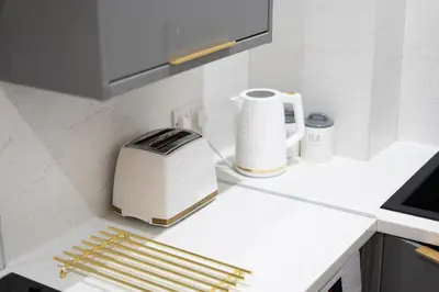 a toaster sitting on a counter in a kitchen at Coatbridge Apartment in Coatbridge