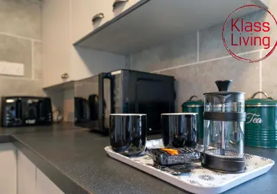 a kitchen counter with a tray with two glasses on it at Alexander Apartment by Klass Living Coatbridge in Coatbridge