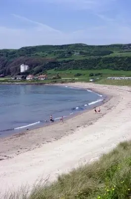 a group of people on a beach near the water at Inishroel Cottage in Campbeltown