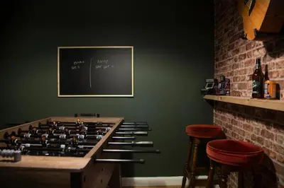 a room with a large group of bottles on a wall at Trendy 2 Bed Flat - Near Airport in Broxburn