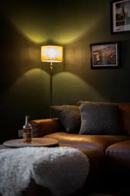 a living room with a couch and a table with a lamp at Trendy 2 Bed Flat - Near Airport in Broxburn