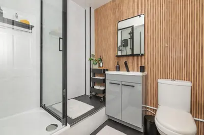 a bathroom with a shower and a toilet and a sink at Trendy 2 Bed Flat - Near Airport in Broxburn