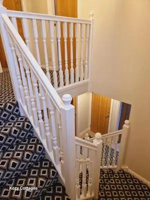 a white staircase with a black and white floor at Ben Arthur Apartment in Lochgoilhead