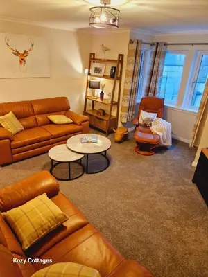 a living room with a couch and a table at Ben Arthur Apartment in Lochgoilhead