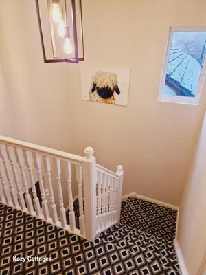 a baby room with a white crib and a window at Ben Arthur Apartment in Lochgoilhead