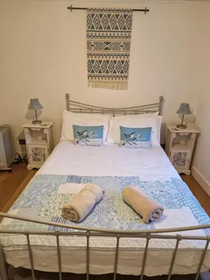 a bedroom with a bed with two towels on it at Langview in Arrochar