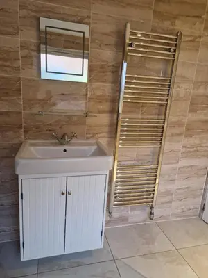 a bathroom with a sink and a mirror at Langview in Arrochar