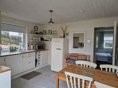 a kitchen with a white refrigerator and a wooden table at Langview in Arrochar