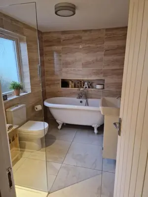 a bathroom with a tub and a toilet and a sink at Langview in Arrochar