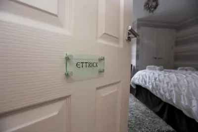 a door with the word crisis written on it next to a bedroom at Viewpoint Villa - Luxury 4 Bedroom villa with elevated views in Rothesay
