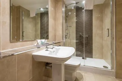 a bathroom with a sink and a toilet and a shower at Macdonald Inchyra Hotel & Spa in Falkirk