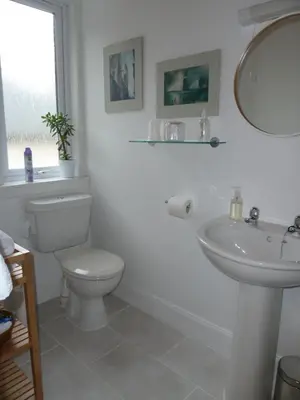 a white bathroom with a toilet and a sink at Failte Bed & Breakfast in Oban