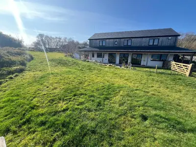 a house on top of a grassy hill at The Pier House in Lochgilphead