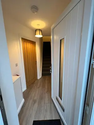 a hallway with a door leading to a stairway at Inchmurrin Townhouse, Loch Lomond in Bonhill