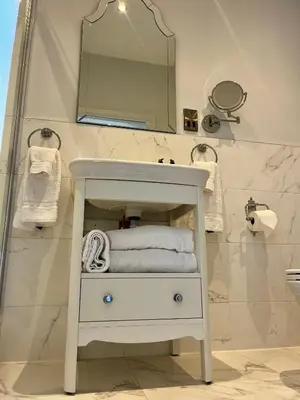 a bathroom with a white sink and a mirror at Abbotsford Hotel in Ayr