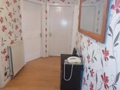 a room with two white doors and a phone in it at Comfortable Rooms With Work Desks In Cheerful Apartment Glasgow City in Glasgow