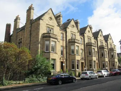 a large brick building with cars parked in front of it at Complete City Centre Comfort in Edinburgh