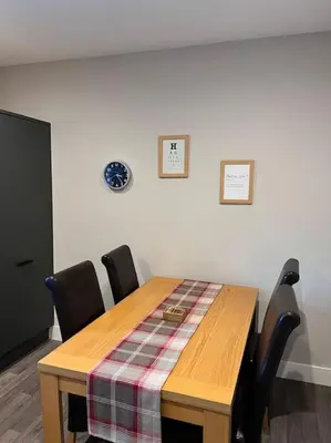 a dining room table with a plaid table cloth on it at Newly refurbished flat - Callander in Callander